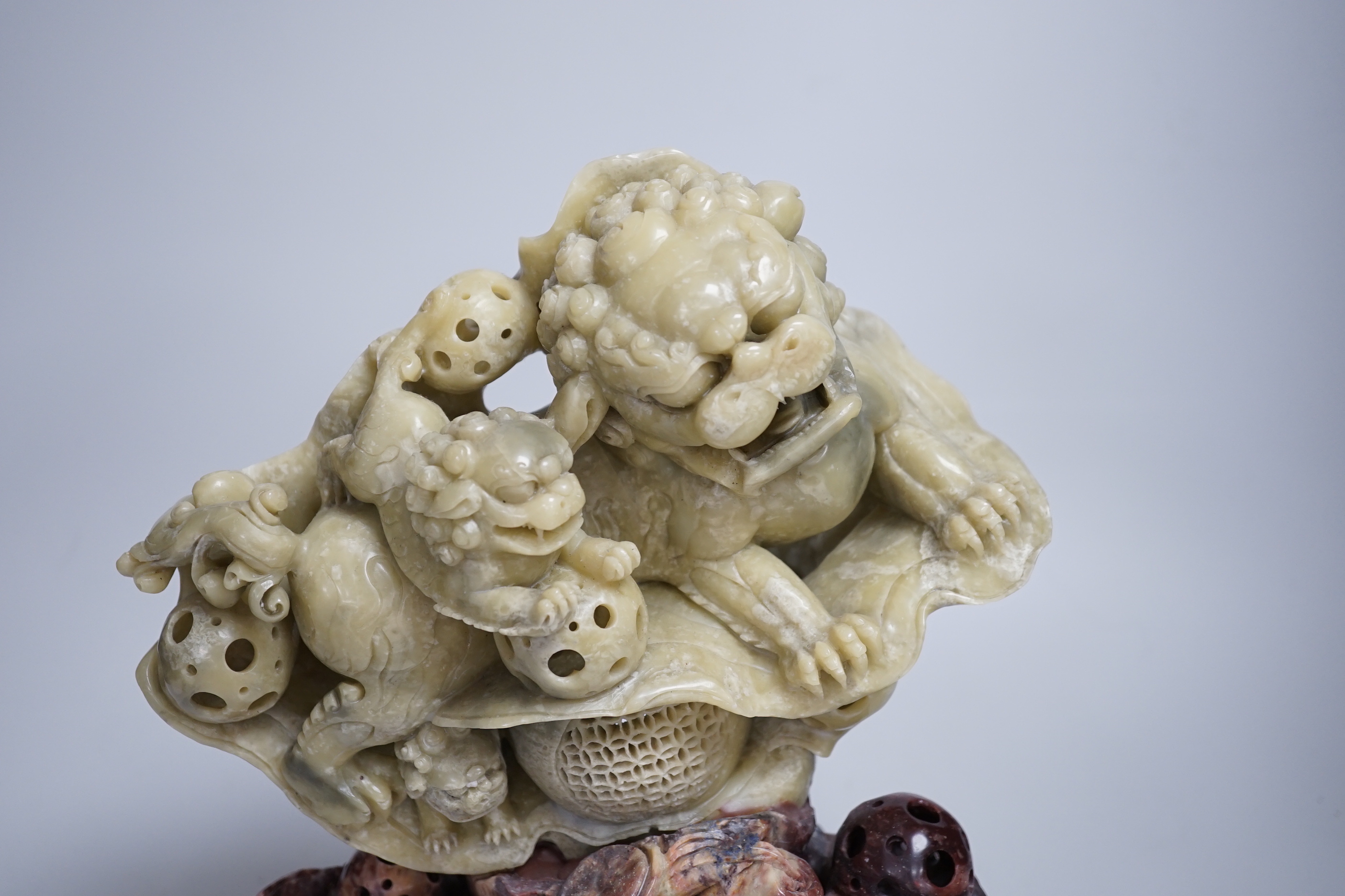 A Chinese soapstone sculpture of a lion dog group, 31.5cm high